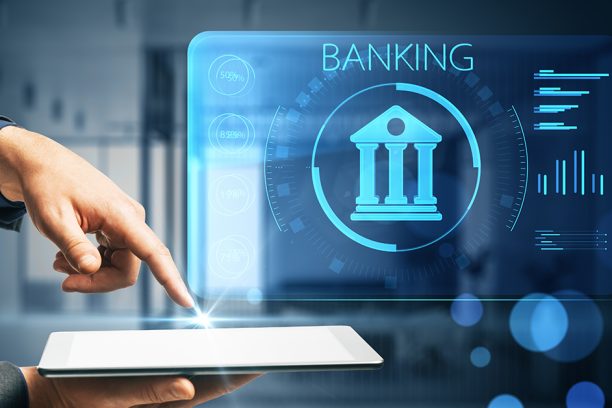 Businessman hand pointing at tablet with creative online banking hologram on blue blurry background. AI and automation concept. Double exposure